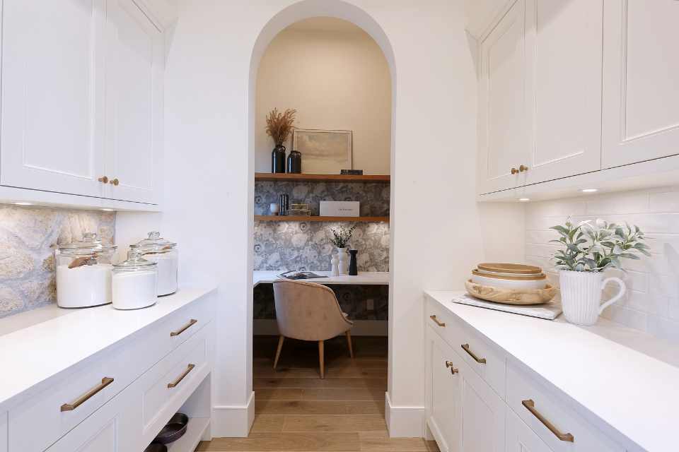 designer office hidden in white european farmhouse style kitchen
